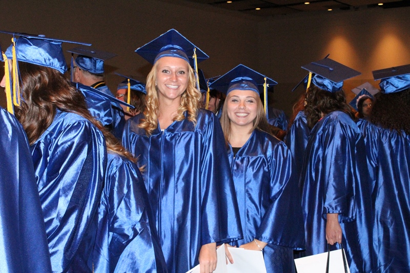 This photo shows a group of students smiling at graduation