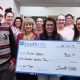 This photo shows Health Careers Club Members with a check for local Lewistown family.