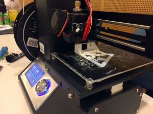 This photo shows a 3D printer creating sensor holders