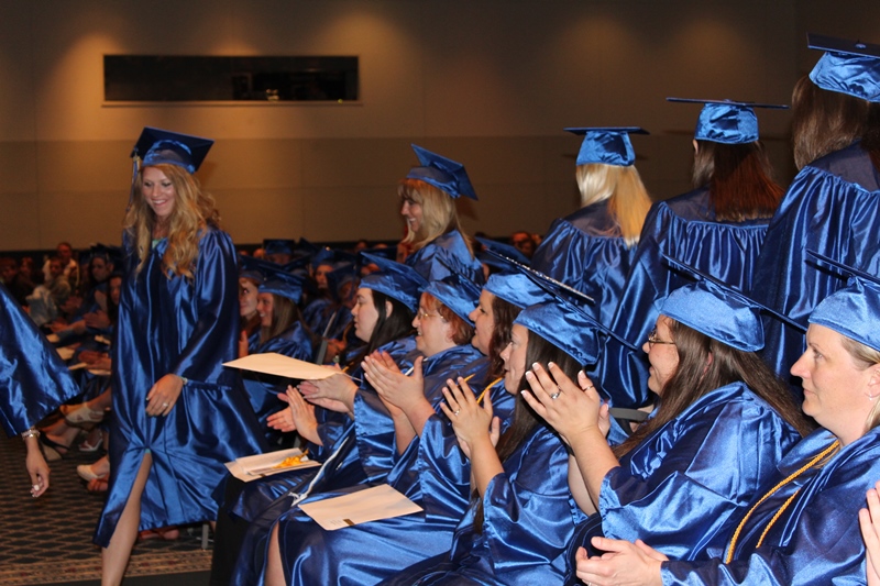 This photo shows a group of students walking at graduation