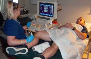 Sonographer examining veins in patient's leg