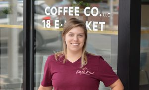 Female standing outside of a coffee shop