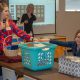 South Hills DMS 2019 class representative Lesley Hogan, left, holds the basket while DMS second-year class representative Robyn Pheasant draws the willing ticket for the 2019 basket raffle. DMS Program Director, Tricia Turner, watches in the background.