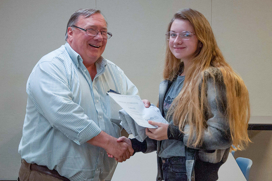 A PA Cyber Charter School student receives her Certified Dronologist certificate from South Hills’ Discover Drones Program Coordinator, Jeff Stachowski.