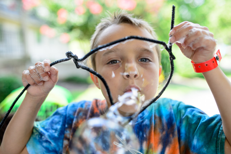 This photo shows a child blowing bubbles
