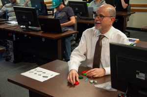 Director of Education, David Schaitkin, following LEGO instructions from Engineering students