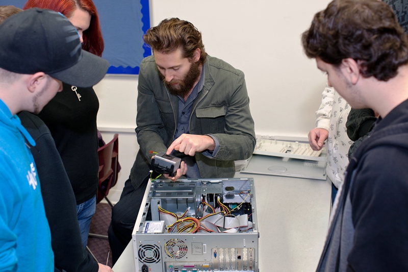 Information Technology instructor showing parts of the computer
