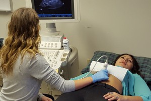 This photo shows sonography students practiving scanning in a medical lab