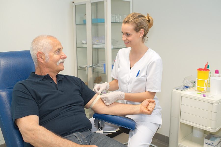 Phlebotomist collecting a patient's blood for testing