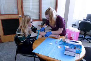 Students of the Medical Assistant specialized associate degree program are shown practicing venipunctures.