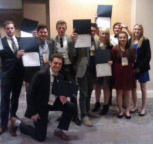 This photo shows smiling students with their awards