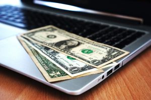 Money sitting on a laptop
