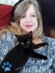 This photo shows the Director of Marketing & Public Relations with her kitten