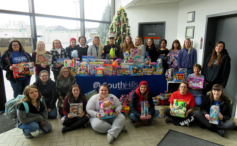 This photo shows Altoona students with toy donations for Toys for Tots